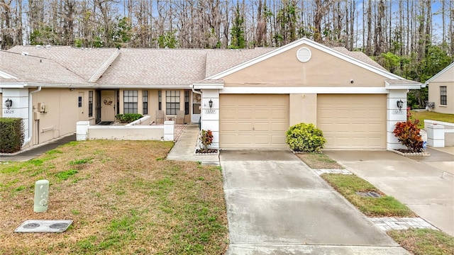 ranch-style home with stucco siding, driveway, a front yard, a shingled roof, and a garage