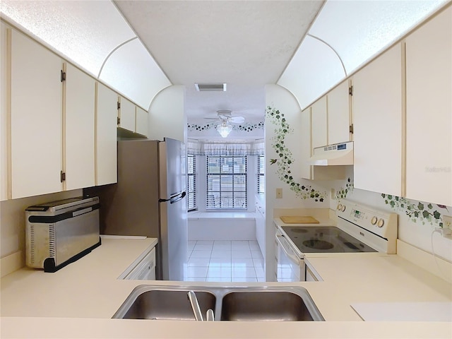 kitchen with visible vents, white electric stove, a sink, light countertops, and under cabinet range hood