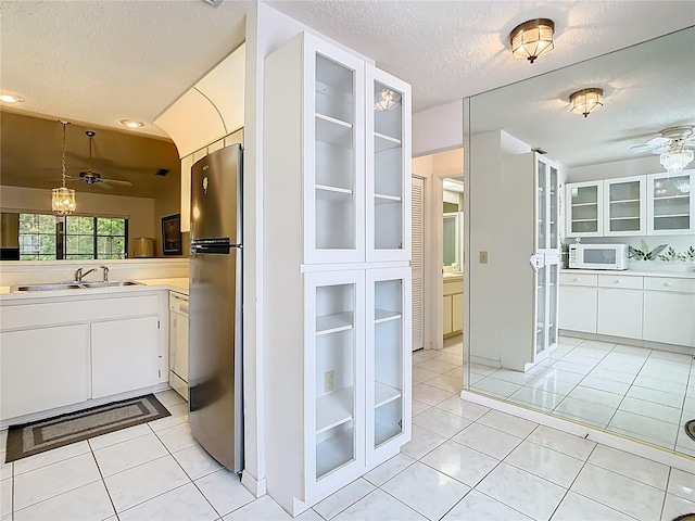 bathroom featuring a textured ceiling, ceiling fan, vanity, and tile patterned flooring