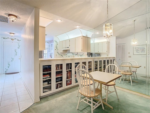 dining room with light tile patterned floors, baseboards, visible vents, recessed lighting, and vaulted ceiling