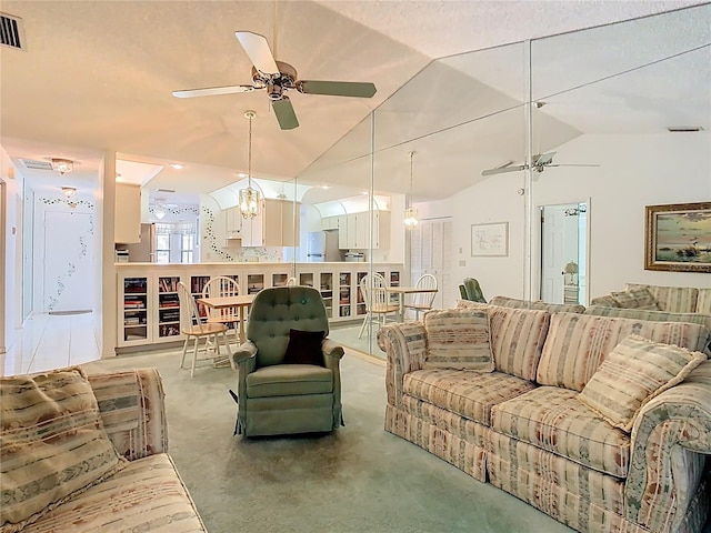 living room with lofted ceiling, visible vents, and ceiling fan