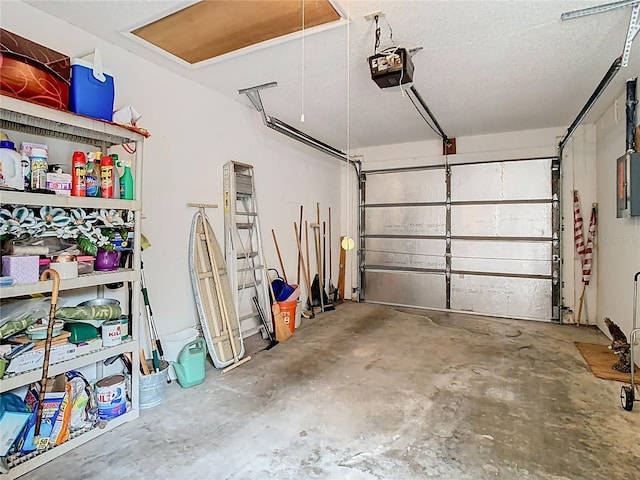 garage featuring electric panel and a garage door opener