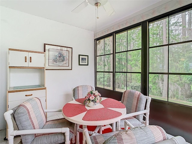 dining space with wood finished floors, plenty of natural light, and ceiling fan