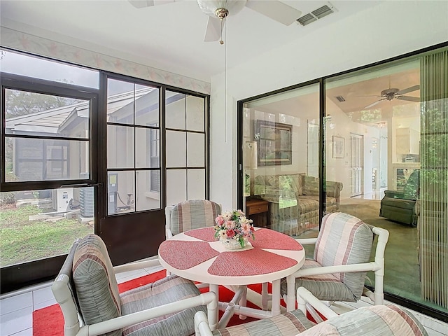 sunroom / solarium with visible vents, cooling unit, and ceiling fan