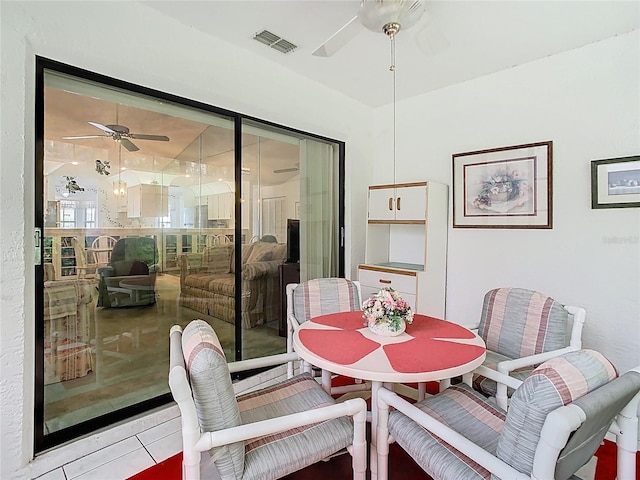 dining area featuring light tile patterned floors, visible vents, and ceiling fan