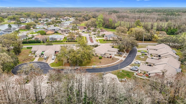 drone / aerial view featuring a forest view and a residential view