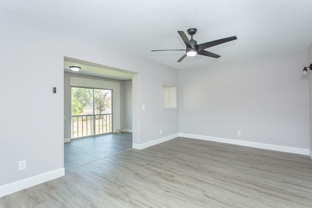 empty room featuring baseboards, wood finished floors, and a ceiling fan