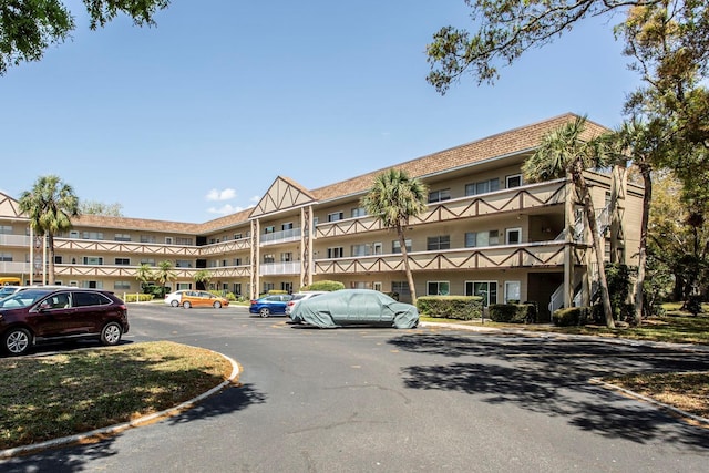 view of property with uncovered parking