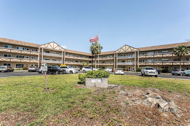 view of building exterior with uncovered parking