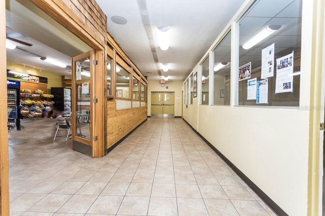 hall featuring light tile patterned floors