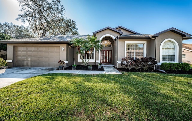 ranch-style house featuring stucco siding, concrete driveway, and a front lawn