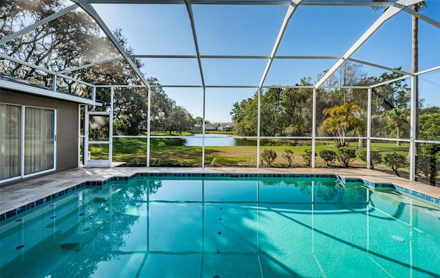 pool featuring a water view, a lanai, and a patio area