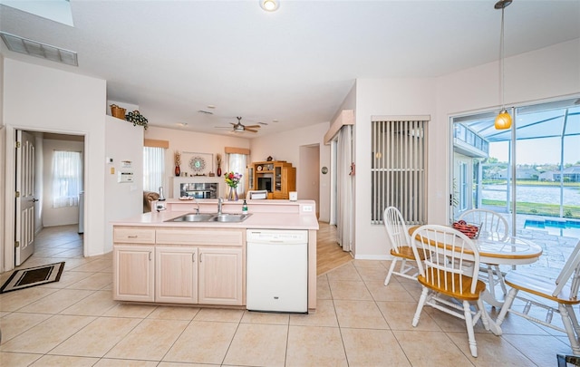 kitchen with visible vents, open floor plan, dishwasher, light tile patterned floors, and a sink