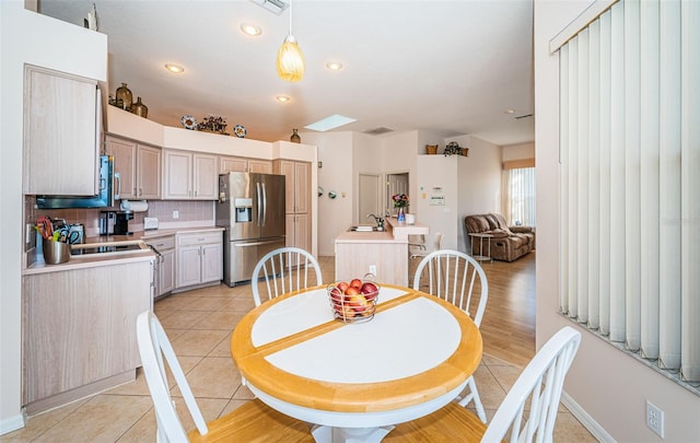 dining space featuring light tile patterned floors and recessed lighting