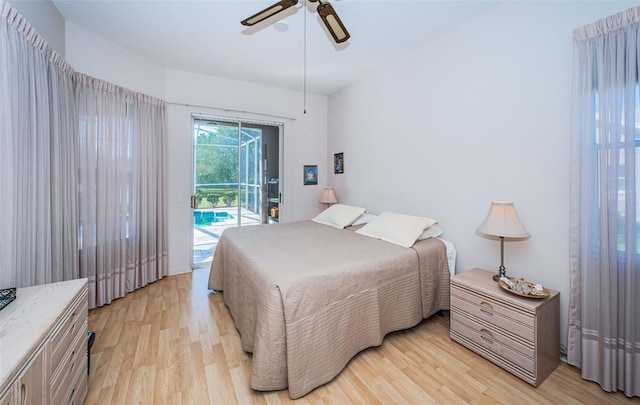 bedroom with access to exterior, light wood finished floors, and a ceiling fan