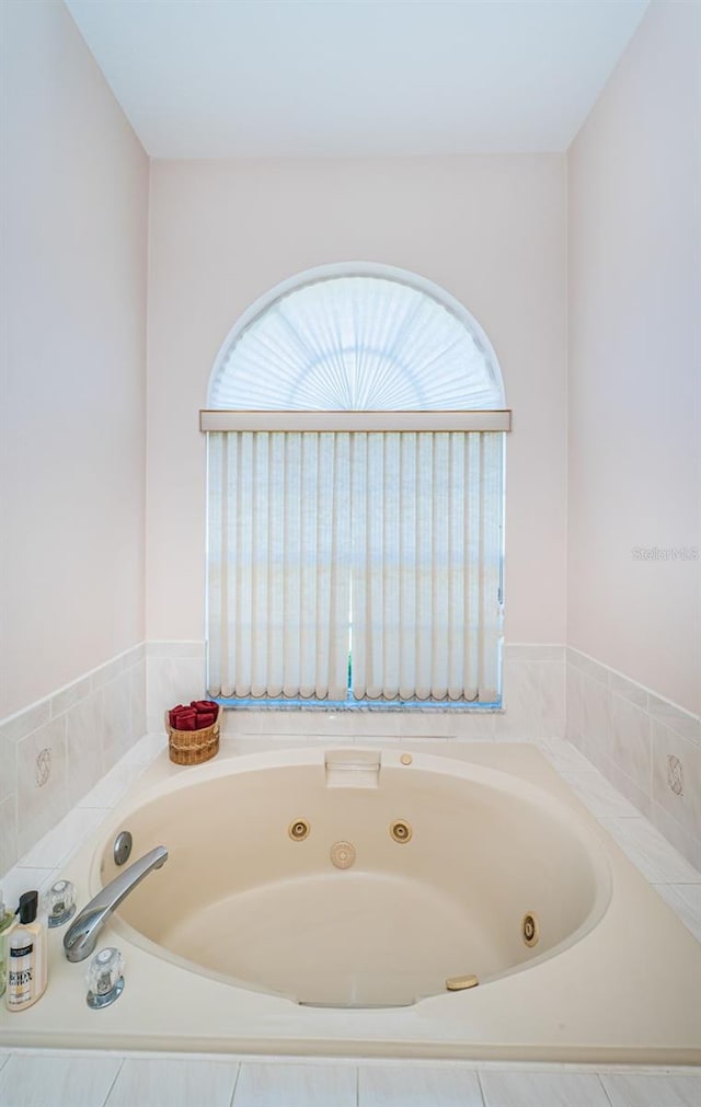 full bath with a whirlpool tub