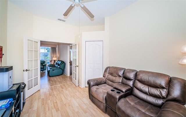 living room featuring light wood-style floors, french doors, visible vents, and ceiling fan