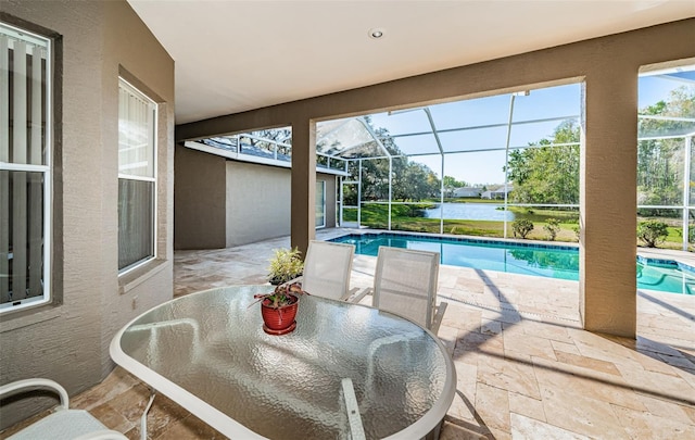 outdoor pool with a patio area, outdoor dining space, and a lanai