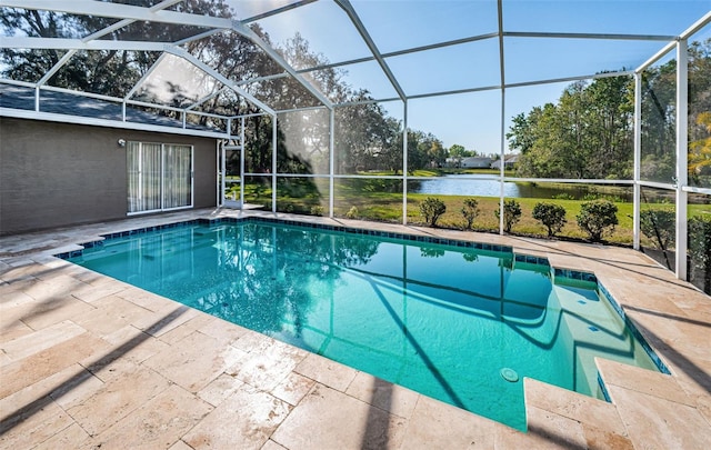 outdoor pool with a patio area, glass enclosure, and a water view