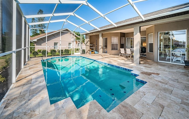 outdoor pool with a lanai and a patio area