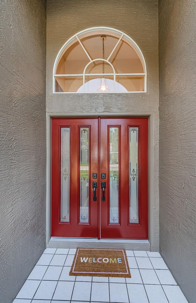 doorway to property featuring stucco siding