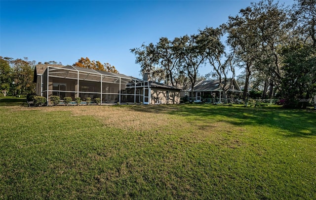 view of yard featuring glass enclosure