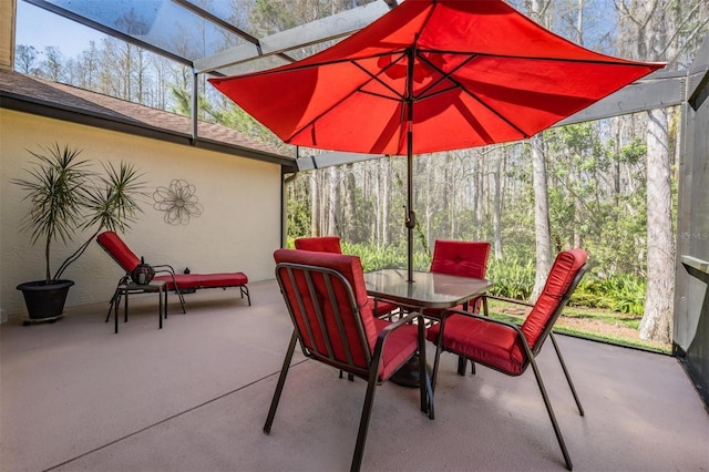 view of patio featuring a lanai and outdoor dining area