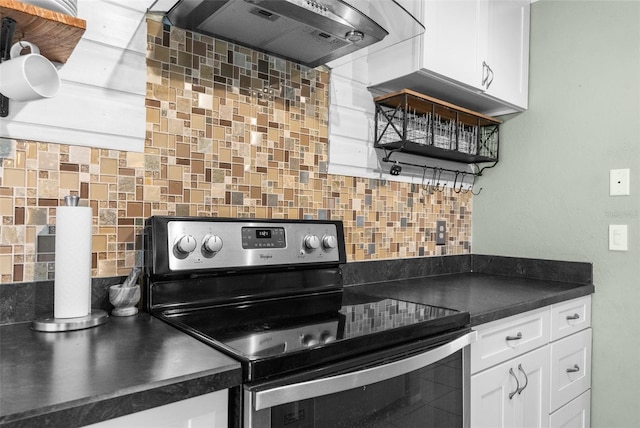 kitchen featuring decorative backsplash, dark countertops, electric range, and wall chimney exhaust hood