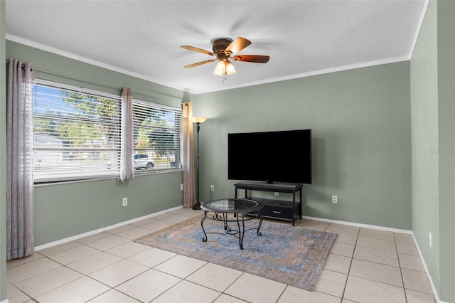 living room with a textured ceiling, crown molding, tile patterned flooring, baseboards, and ceiling fan