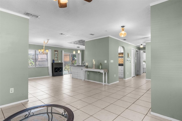 unfurnished living room featuring visible vents, light tile patterned flooring, and ornamental molding