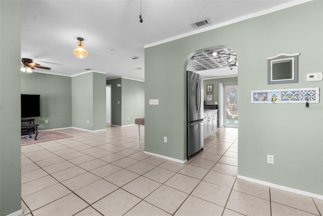 unfurnished room featuring light tile patterned floors, visible vents, and ornamental molding