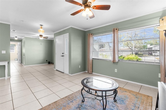 sitting room featuring light tile patterned flooring, a ceiling fan, a wealth of natural light, and ornamental molding