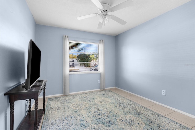 interior space with baseboards and ceiling fan