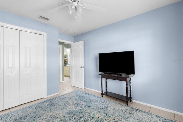 unfurnished bedroom featuring tile patterned floors, visible vents, baseboards, and a closet