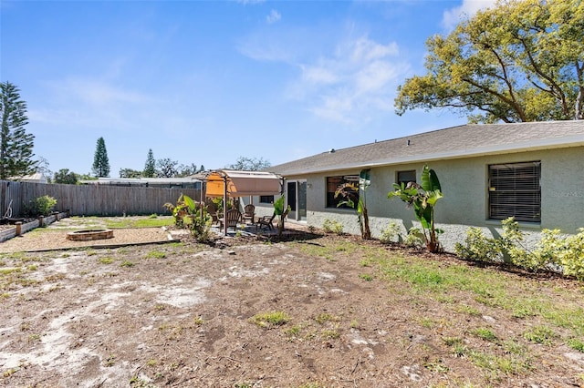 exterior space featuring a patio, fence, and an outdoor fire pit