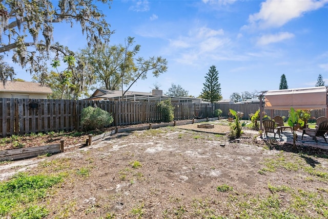 view of yard with a patio area, a fire pit, and a fenced backyard