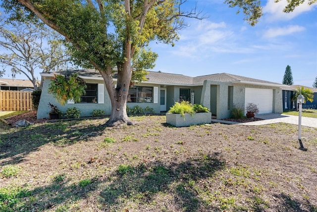 single story home featuring concrete driveway, fence, a garage, and stucco siding