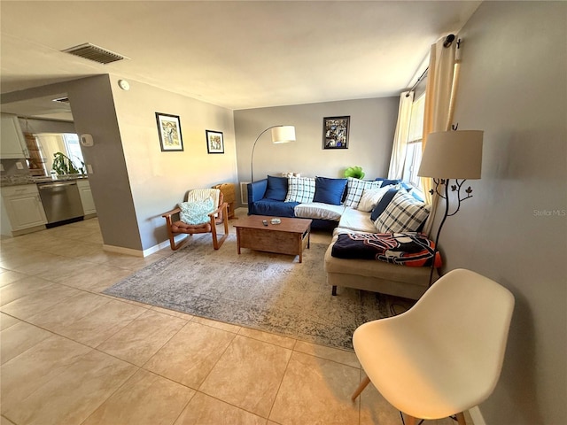 living area with light tile patterned floors, baseboards, and visible vents