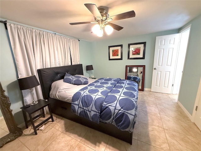 tiled bedroom featuring baseboards and ceiling fan