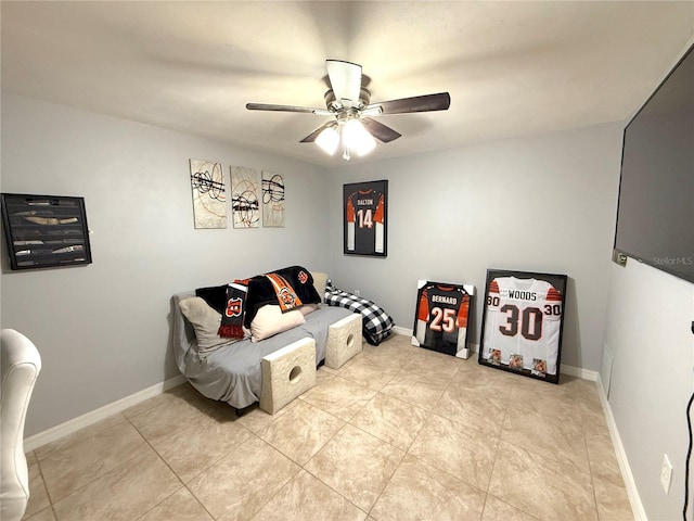 bedroom with baseboards, light tile patterned flooring, and a ceiling fan