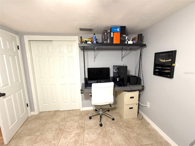 office space with light tile patterned floors, baseboards, and visible vents