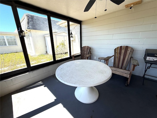 sunroom with a ceiling fan