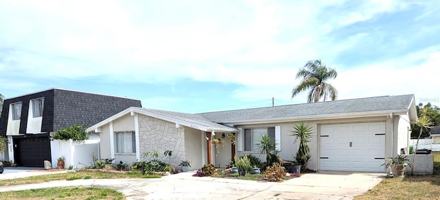 4030 Grayton Dr, New Port Richey, FL 34652 - view of front facade featuring concrete driveway, an attached garage, a shingled roof, and stucco siding