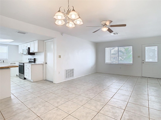 kitchen with visible vents, stainless steel range with electric stovetop, and light countertops