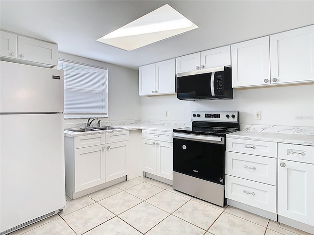 kitchen with a sink, stainless steel appliances, and white cabinets