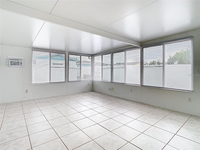 unfurnished sunroom with a healthy amount of sunlight and an AC wall unit