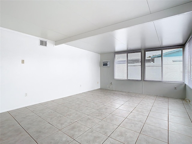 unfurnished room featuring visible vents and beam ceiling