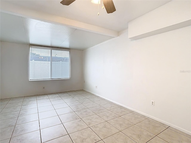 empty room with beam ceiling and a ceiling fan