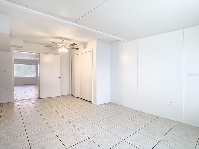 empty room featuring light tile patterned floors and a ceiling fan