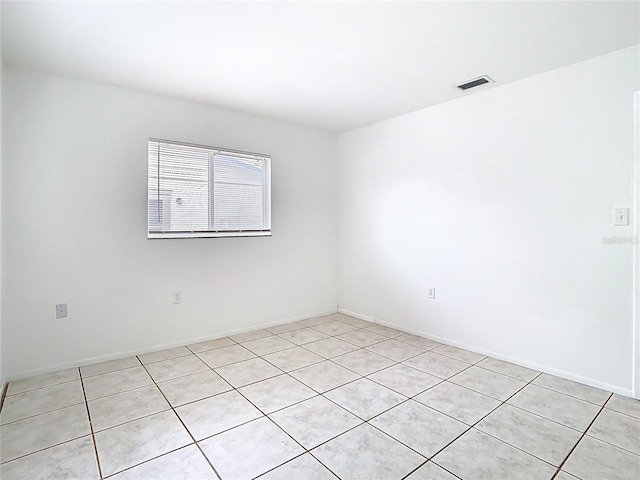 spare room featuring visible vents and baseboards